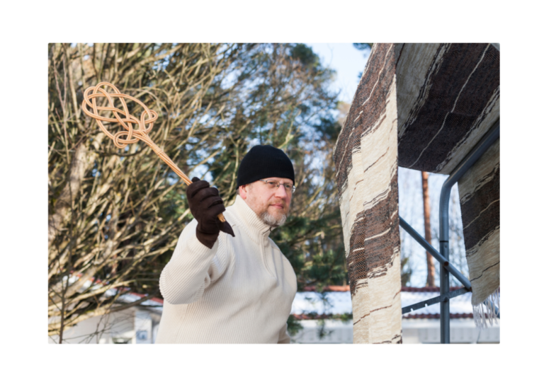 A man swinging a stick at an object, demonstrating Newton's First Law where an object at rest stays at rest until acted upon by an external force.
