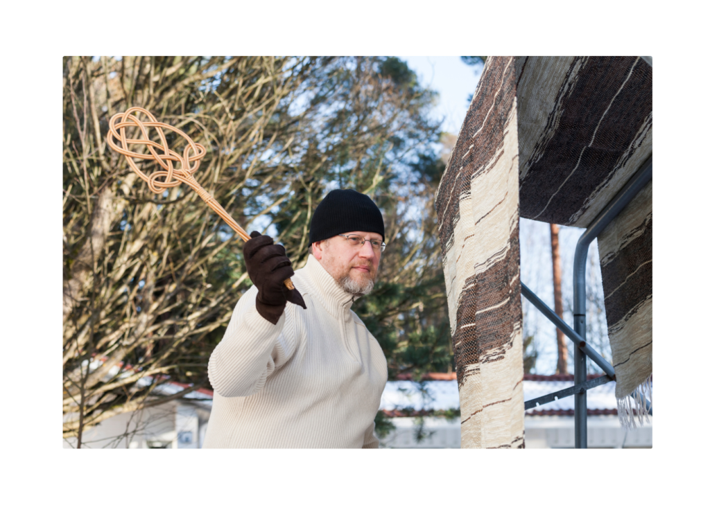 A man swinging a stick at an object, demonstrating Newton's First Law where an object at rest stays at rest until acted upon by an external force.