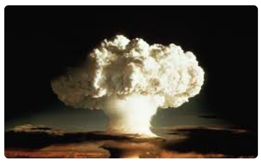 A large mushroom cloud rising from a nuclear explosion, showing the power of atomic energy.