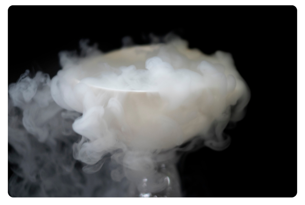 White bowl with thick white vapour or smoke rising and spreading, showing evaporation and sublimation